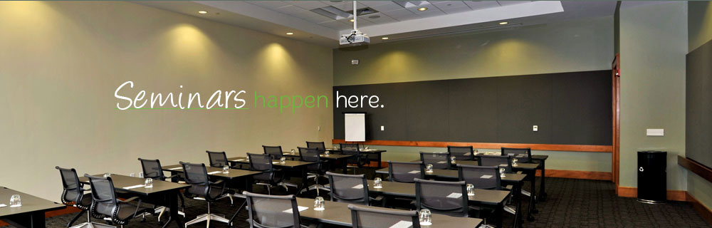 Seminar room with tables, chairs, and presentation screen