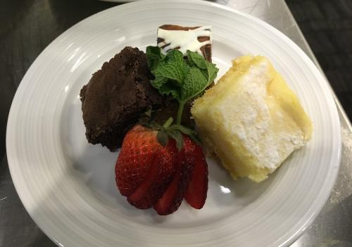 Elegant dessert along with assorted sweets over a plate